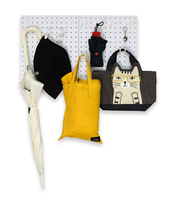 Pegboard placed by the door, used for organizing umbrellas and bags.