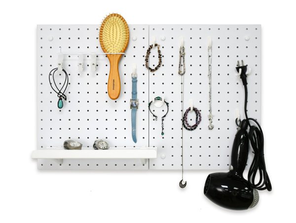 Pegboard used to organize accessory, a hair dryer, and a comb.